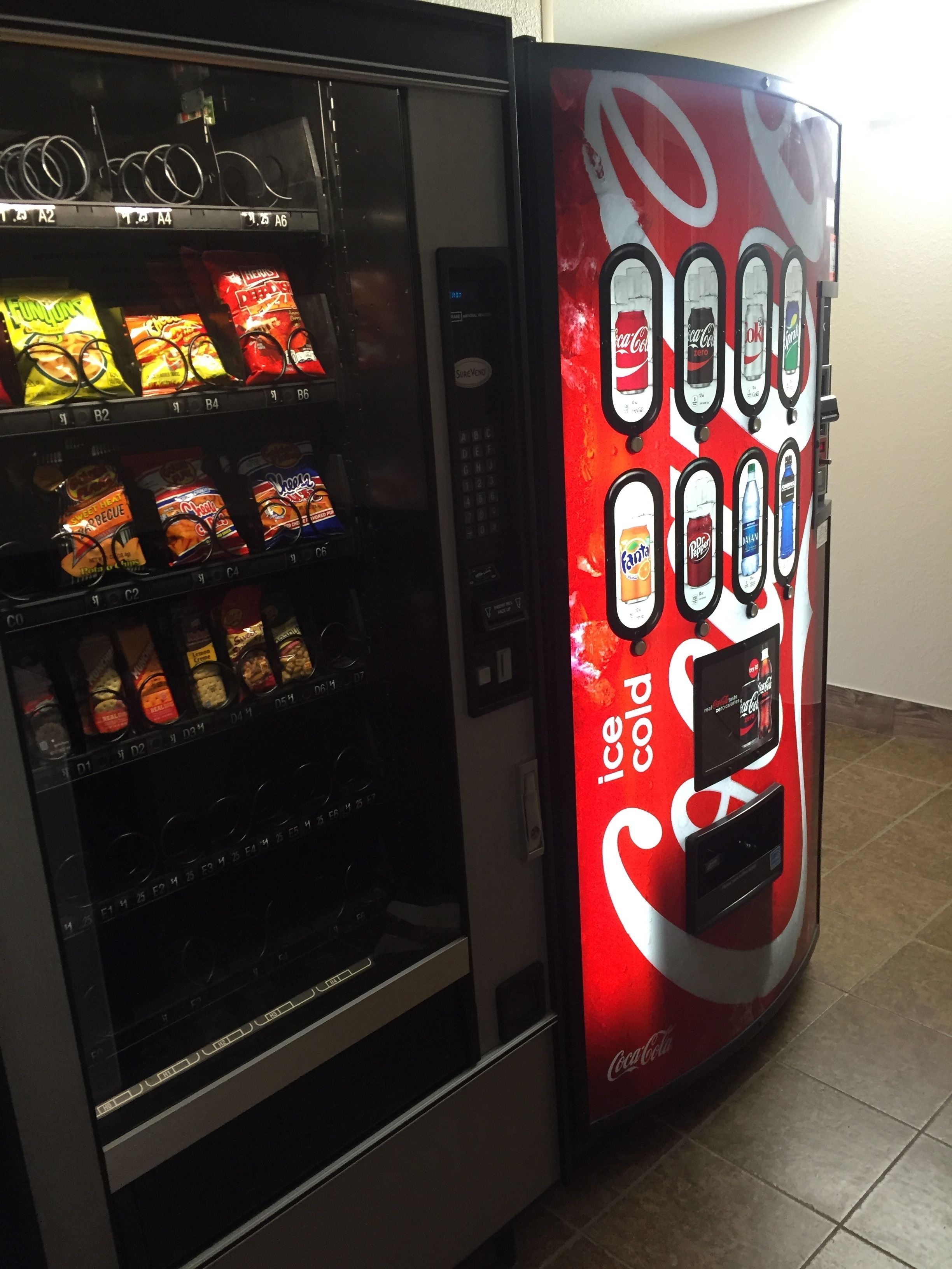 A vending machine with snacks and a Coca-Cola branded dispenser.