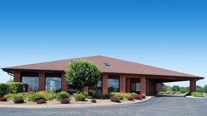 A modern building with a flat roof, large windows, and a covered entrance area. - Blisspoint Inn Columbia City (Columbia City)