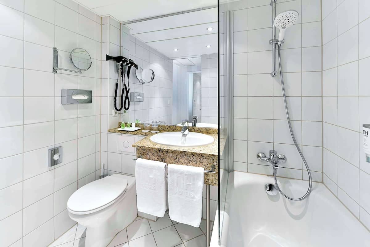 deep-soaking bathtub, eco-friendly toiletries, hair dryer, towels