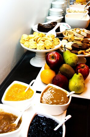 A buffet with various food items including fruits, pastries, and desserts. - Ulises Recoleta Suites (Buenos Aires)