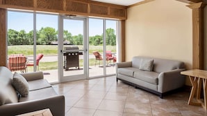A spacious living area with a sliding glass door leading to an outdoor patio.