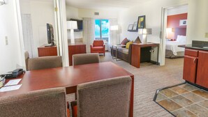 A hotel room with a dining area, a sofa, a TV, and a bed. - Residence Inn by Marriott Fort Worth Alliance Airport (Fort Worth)