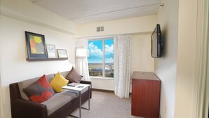 A living room with a sofa, a coffee table, a TV mounted on the wall, and a window with curtains. - Residence Inn by Marriott Fort Worth Alliance Airport (Fort Worth)