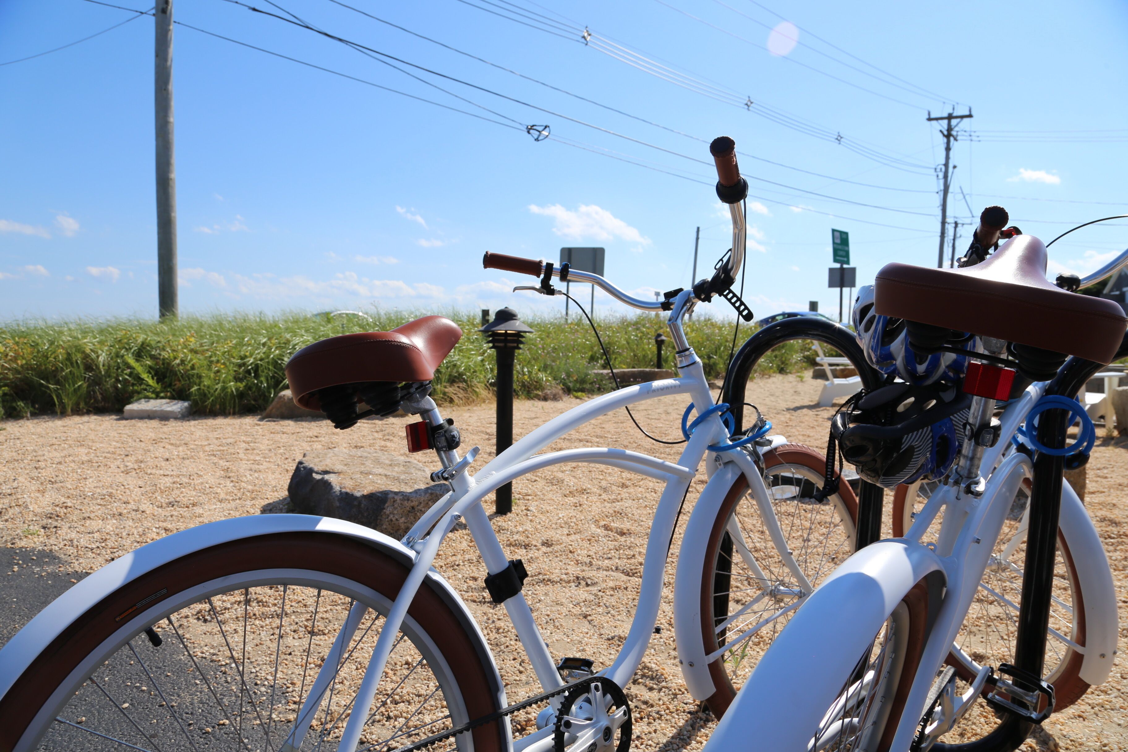 Una bicicleta estacionada en una zona arenosa con cielo despejado al fondo.