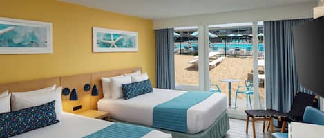 A hotel room with two beds, a desk, and a view of a pool area.