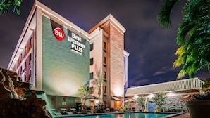 A hotel with a pool area, outdoor seating, and a sign for 'Best Western Plus'. - Best Western Plus Hollywood/Aventura (Hallandale Beach)