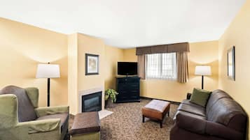 A living room with a fireplace, a television, and a sofa.