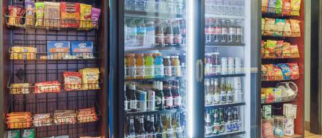 A vending machine stocked with snacks, drinks, and bottled water.