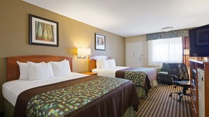 A hotel room with two beds, a desk with a chair, a television, and two framed pictures on the wall. - Best Western Windsor Inn (Dumas)