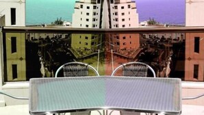 A mirrored view of a building with a central reflective surface, possibly a pool or a decorative element, and a reflection of the building's facade. - Duroy Hotel (Beirut)