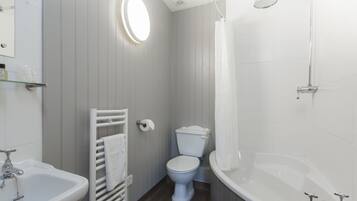 A bathroom with a toilet, sink, and bathtub.