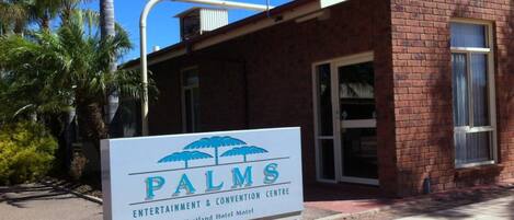 A sign for the PALMS Entertainment & Convention Centre at the Westland Hotel Motel.