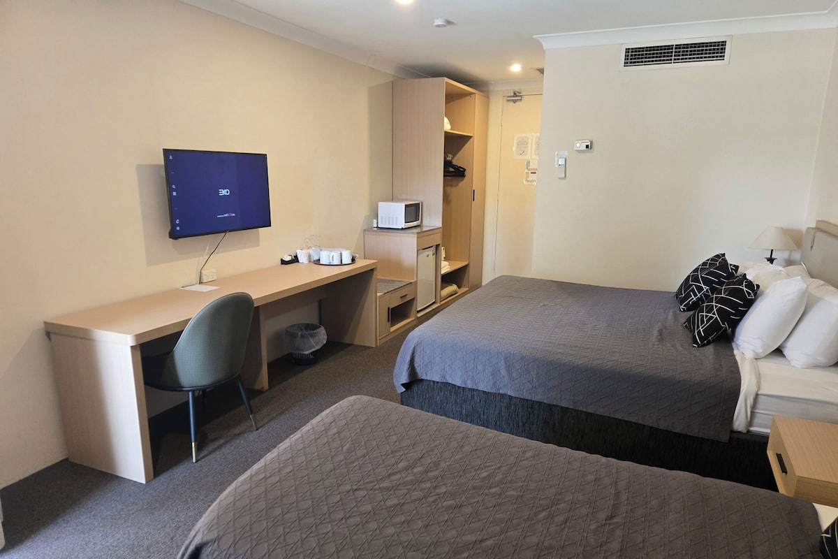 Desk, laptop workspace, blackout drapes, iron/ironing board