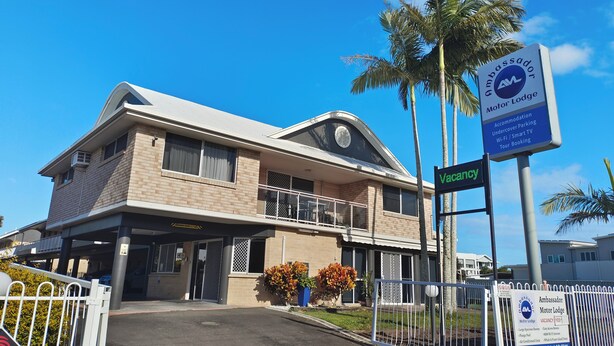 A two-story building with a balcony, a signboard for Ambassador Motor Lodge, and a gated entrance. - Ambassador Motor Lodge (Hervey Bay)