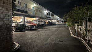 A multi-story parking garage with several cars parked. - Ambassador Motor Lodge (Hervey Bay)