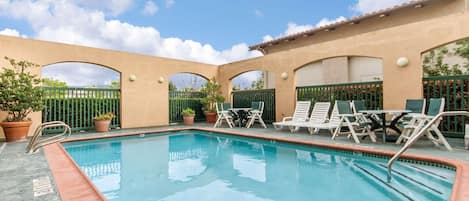 Seasonal outdoor pool, open 6 AM to 10:30 PM, pool umbrellas