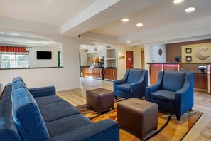 A hotel lobby with seating, a reception desk, and a television. - Comfort Inn South San Jose / Morgan Hill (Morgan Hill)