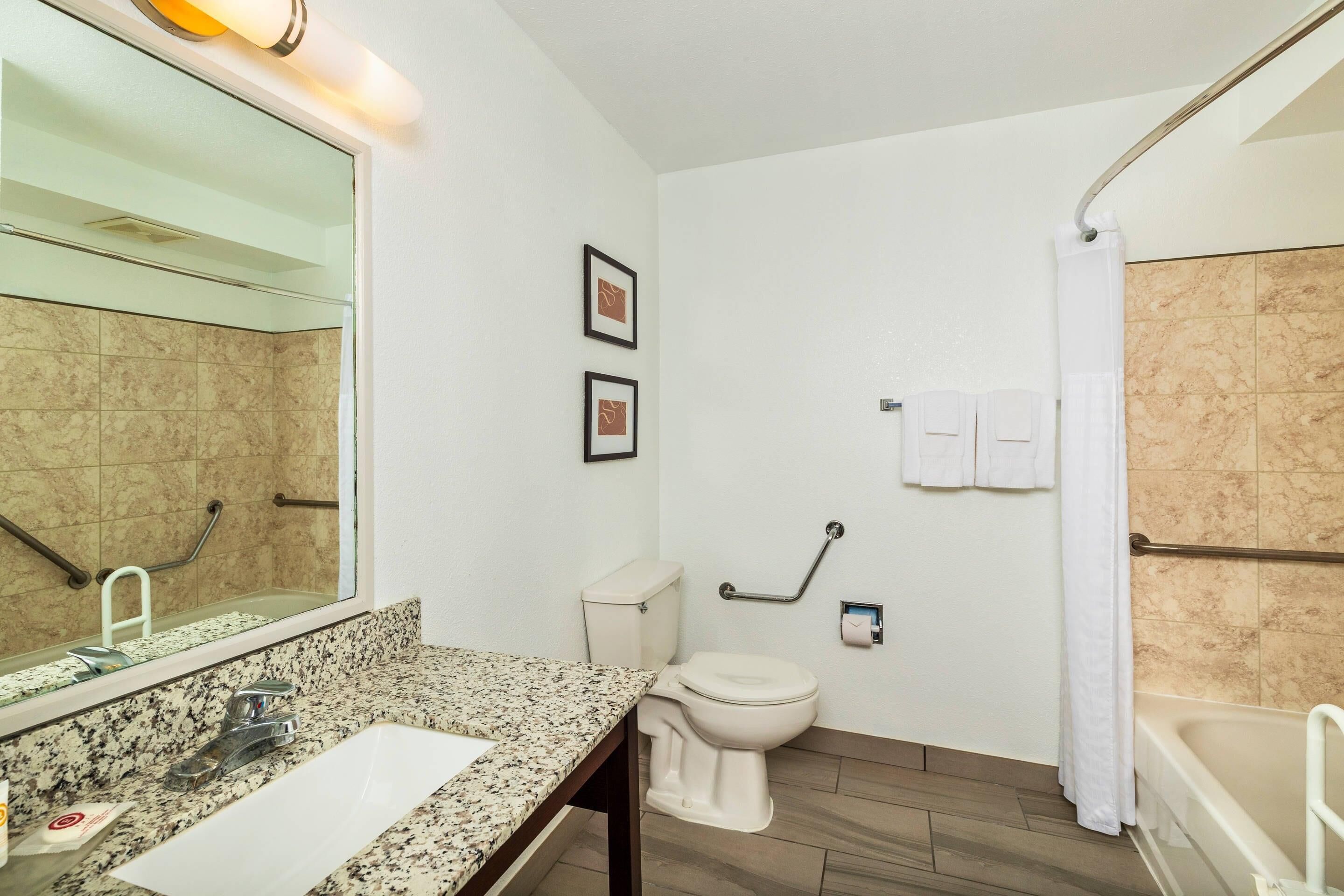 A bathroom with a sink, toilet, and bathtub.
