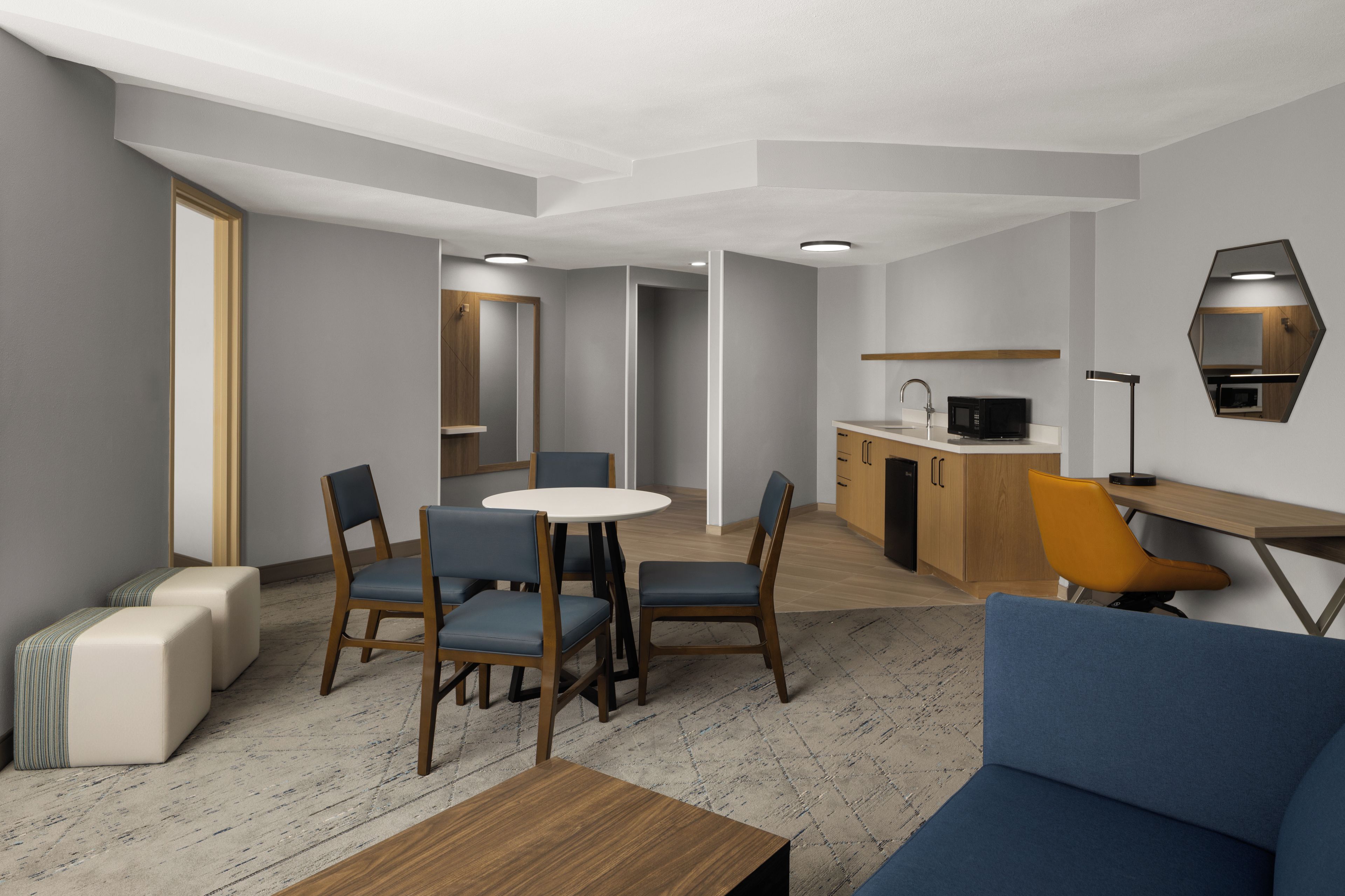 A modern interior with a dining area, kitchen, and seating space.
