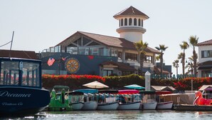 A marina with boats docked, a clock, and a building with a tower. - Holiday Inn Express Port Hueneme by IHG (Port Hueneme)