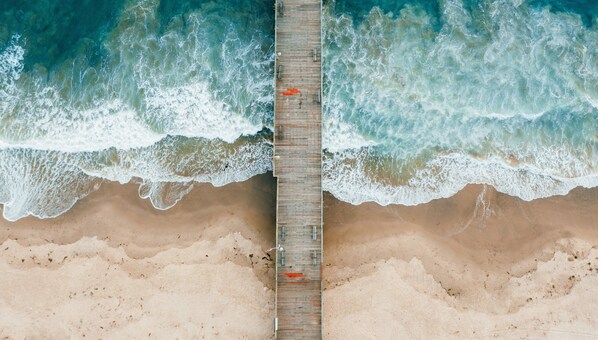A wooden pier extending into a beach with waves crashing on both sides. - Holiday Inn Express Port Hueneme by IHG (Port Hueneme)