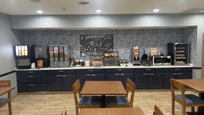 A breakfast bar with seating, a coffee machine, and a microwave. - AmericInn by Wyndham Galesburg (Galesburg)