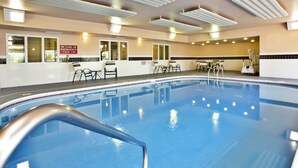 An indoor swimming pool with clear water, a lifeguard chair, and a sign indicating emergency procedures. - Country Inn & Suites by Radisson, Marion, OH (Marion)