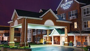A brick building with a sign reading "Country Inn & Suites by Radisson." - Country Inn & Suites by Radisson, Milwaukee West (Brookfield), WI (Brookfield)