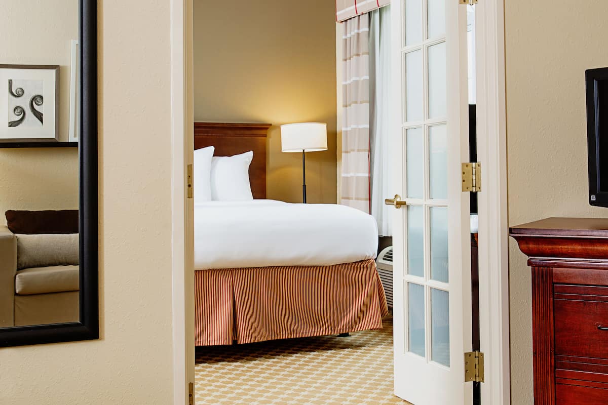 Premium Suite, 1 King Bed, Non Smoking | Desk, laptop workspace, blackout drapes, iron/ironing board