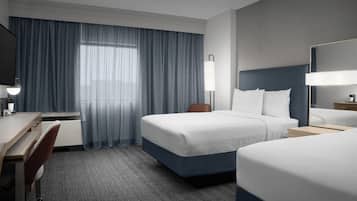 Premium bedding, desk, laptop workspace, blackout drapes