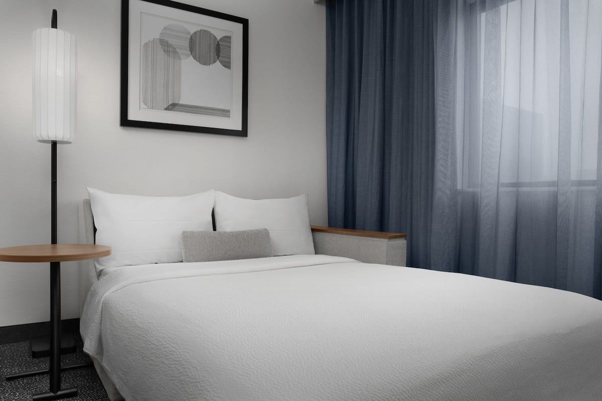 premium bedding, desk, laptop workspace, blackout curtains