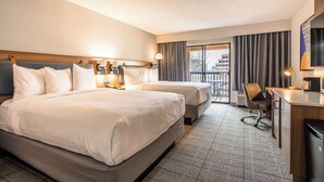 A hotel room with two beds, a desk, and a chair. - Sonesta Select Dallas Richardson (Richardson)