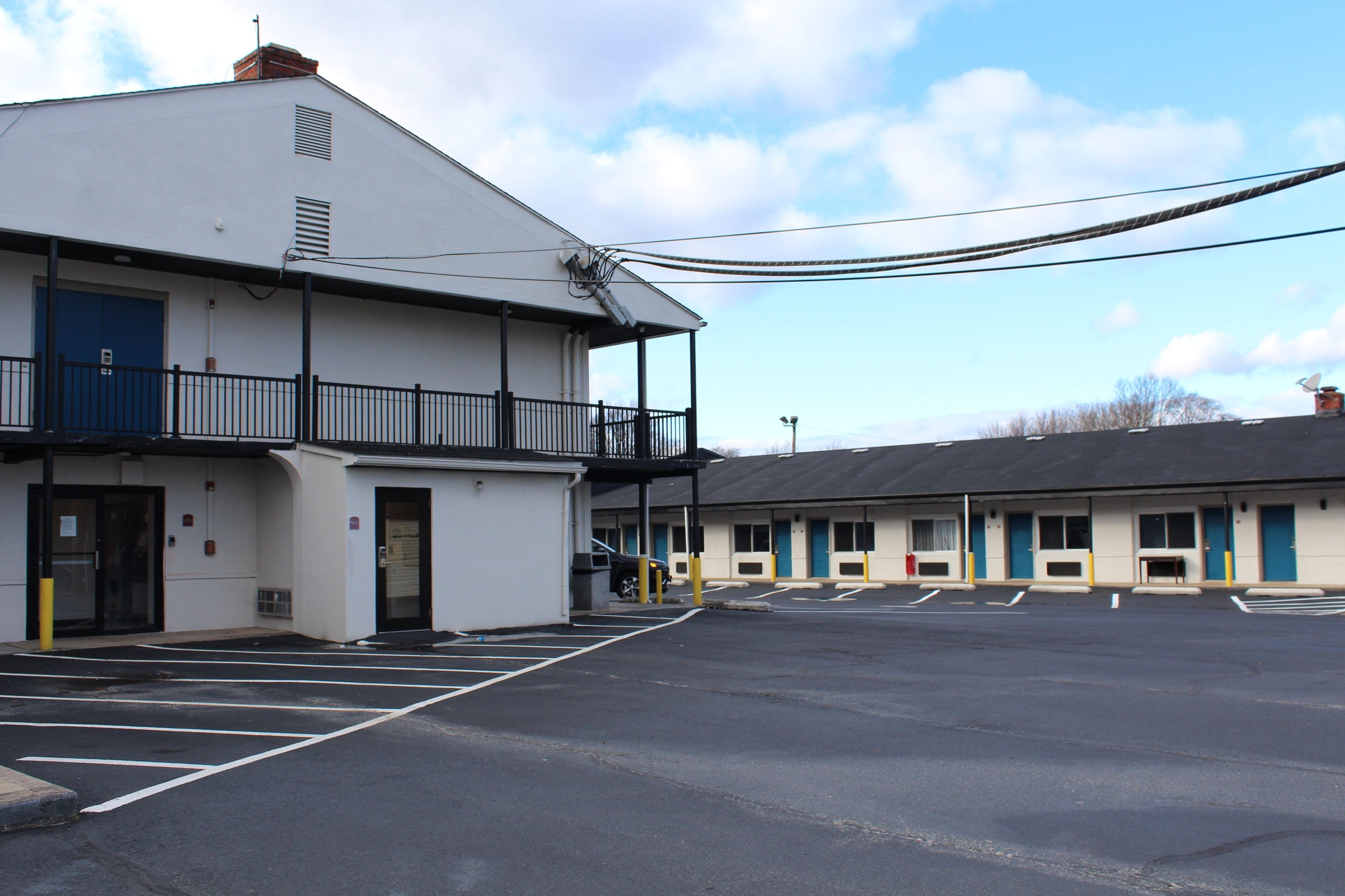 A two-story motel with a parking lot.