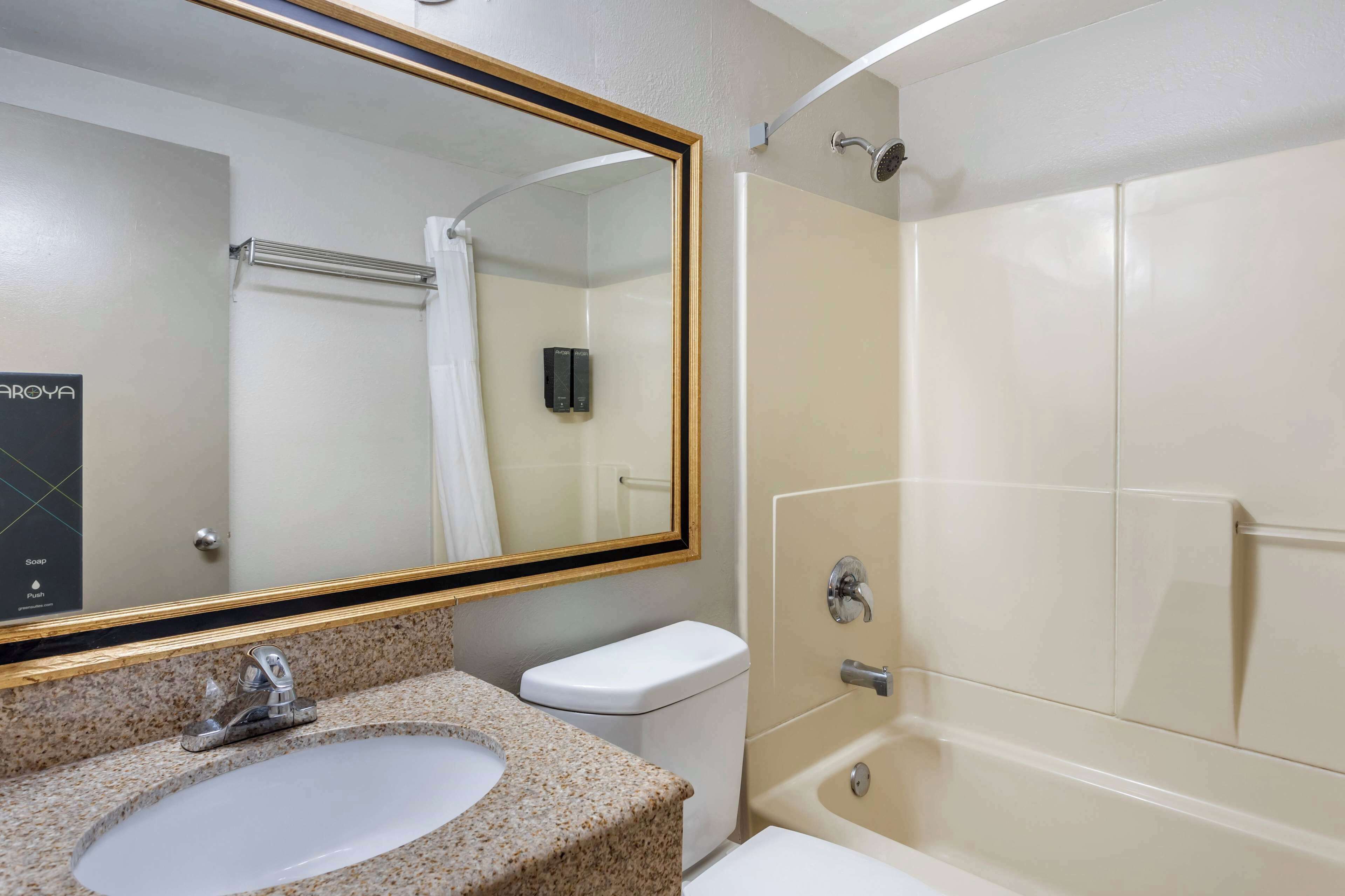 A bathroom with a sink, toilet, and shower.