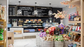 A bakery section with a variety of baked goods displayed in glass cases and baskets.