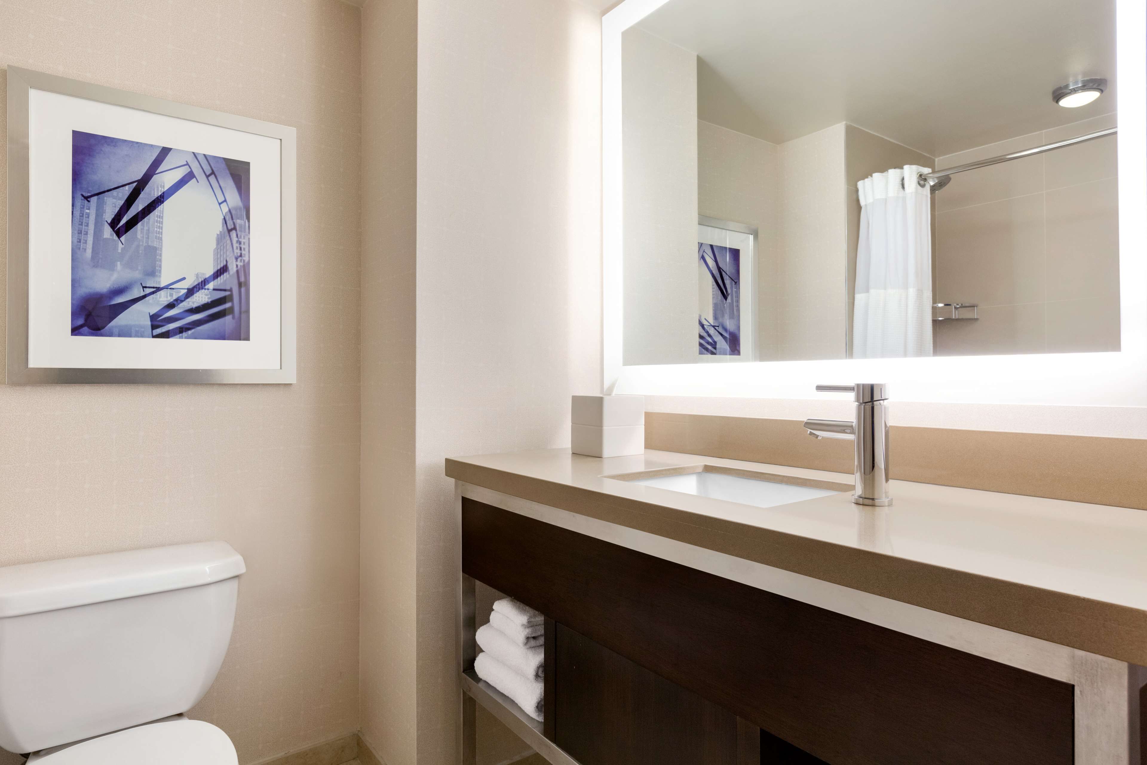 combined shower/bathtub, designer toiletries, hair dryer, bathrobes