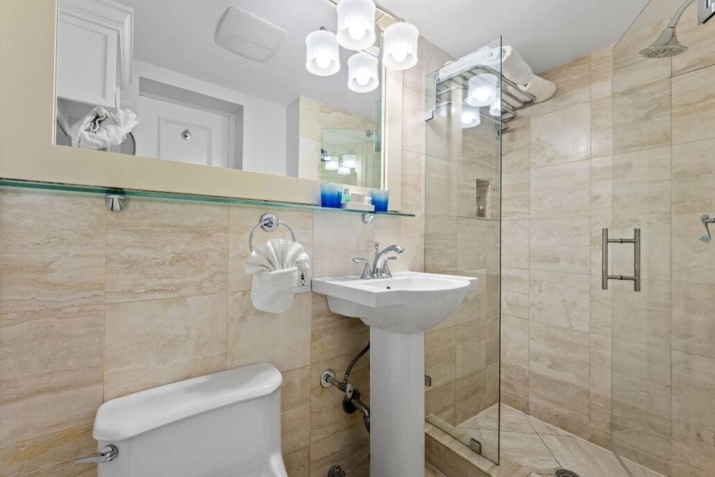 king deluxe poolside room | bathroom | shower, designer toiletries, hair dryer, bathrobes