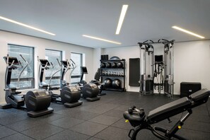 Work out in style with our fully equipped gym featuring elliptical machines, a bench press, and cable machine.