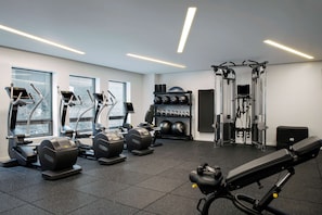 Work out in style with our fully equipped gym featuring elliptical machines, a bench press, and cable machine.