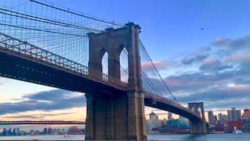 A large suspension bridge with two towers and a roadway spanning a body of water.