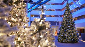 A modern building with a large Christmas tree in the center.