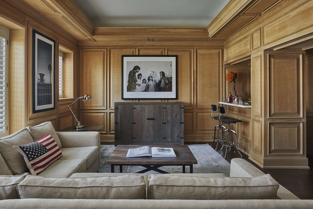 A living room with a sofa, coffee table, and a framed photograph on the wall.