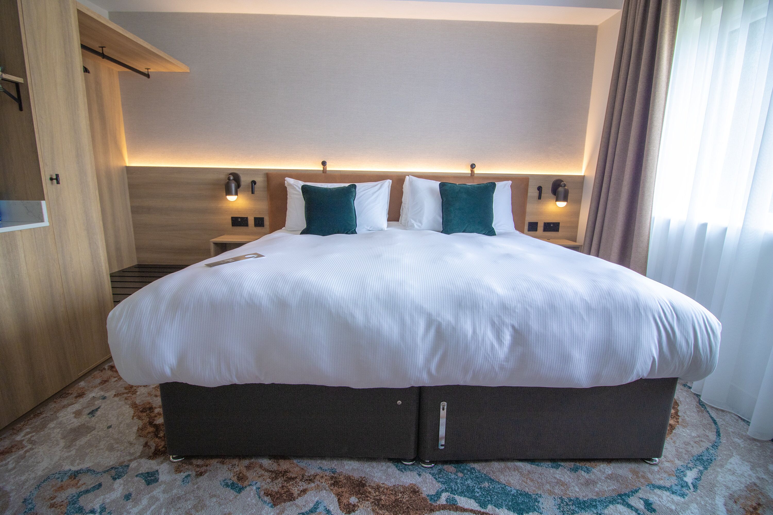 Premium bedding, desk, laptop workspace, blackout curtains