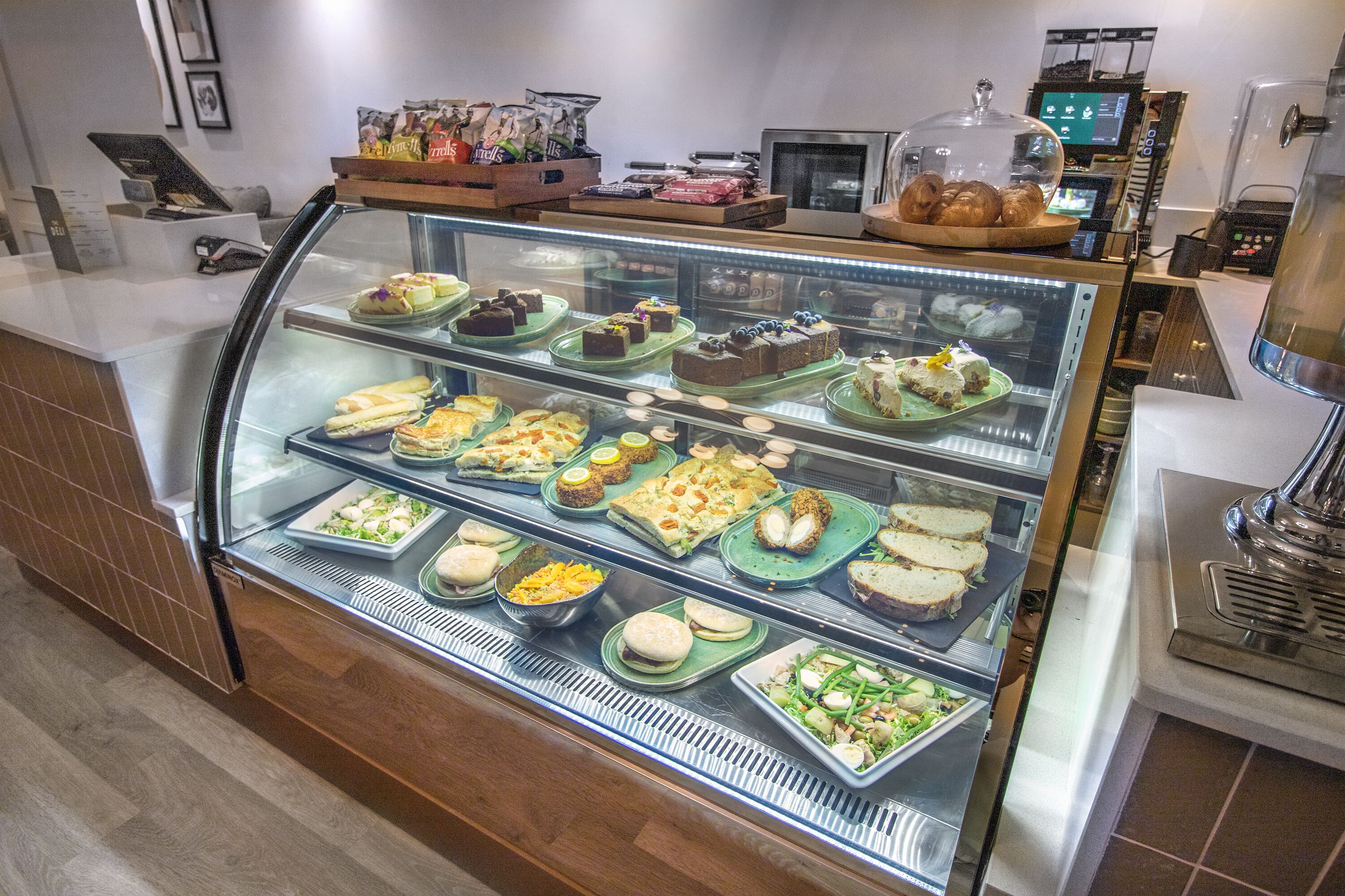 A bakery display case with various pastries and desserts.