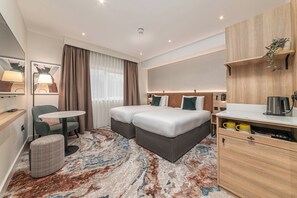 Premium bedding, desk, laptop workspace, blackout drapes