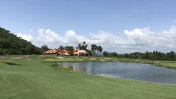 Enjoy a round of golf surrounded by serene water and lush greenery.