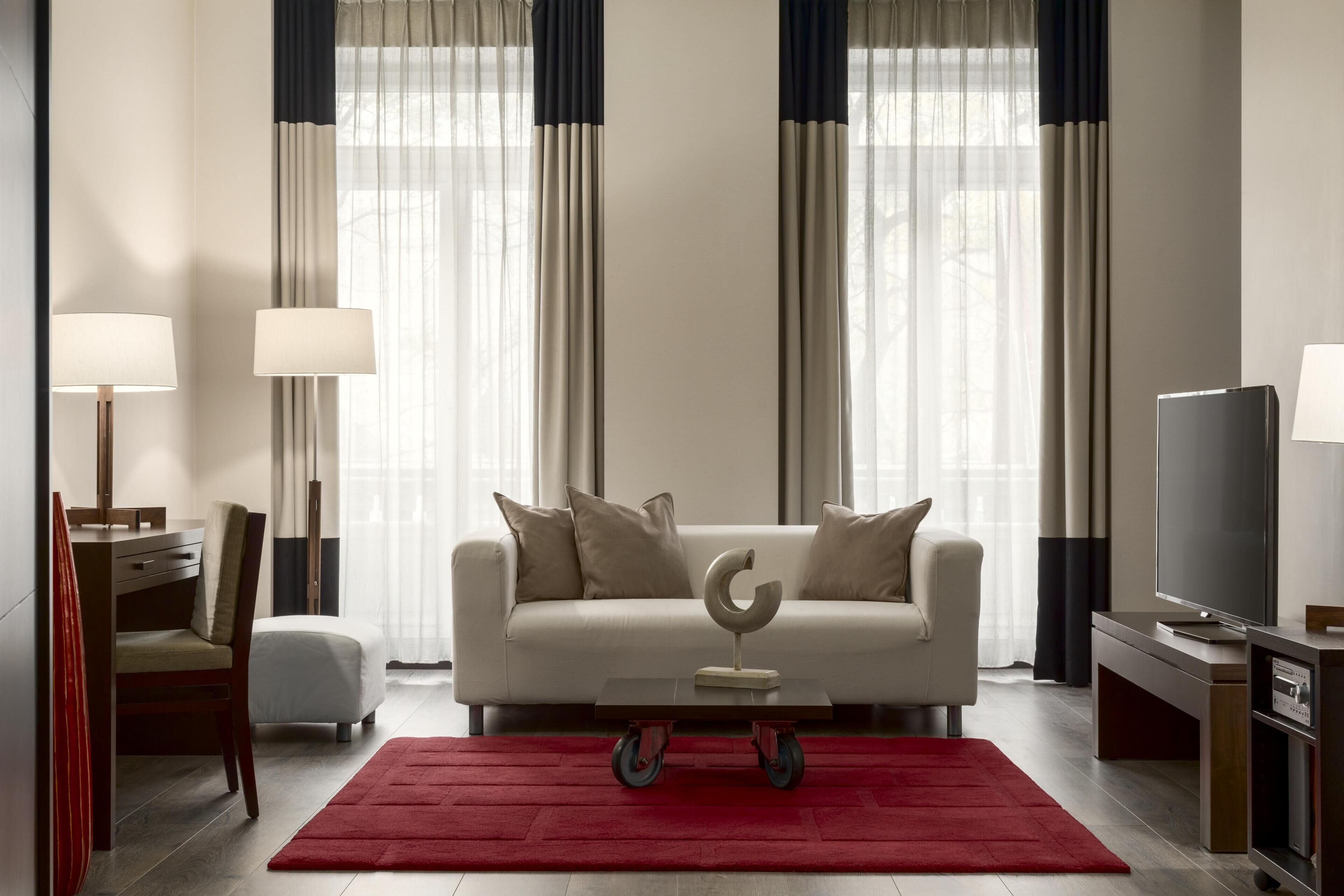 A modern living room with a sofa, coffee table, and TV.