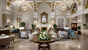 A grand lobby with marble floors, elegant furniture, and ornate ceiling decorations. - The Hermitage Hotel (Nashville)