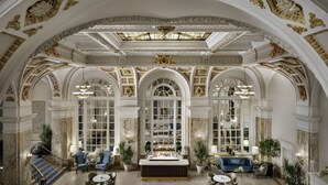 A grand lobby with high ceilings, ornate gold detailing, and a central bar area. - The Hermitage Hotel (Nashville)