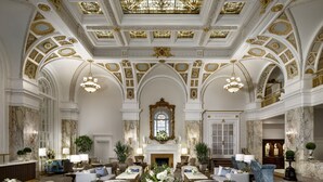 A grand lobby with a high ceiling, ornate gold detailing, and a central chandelier. - The Hermitage Hotel (Nashville)
